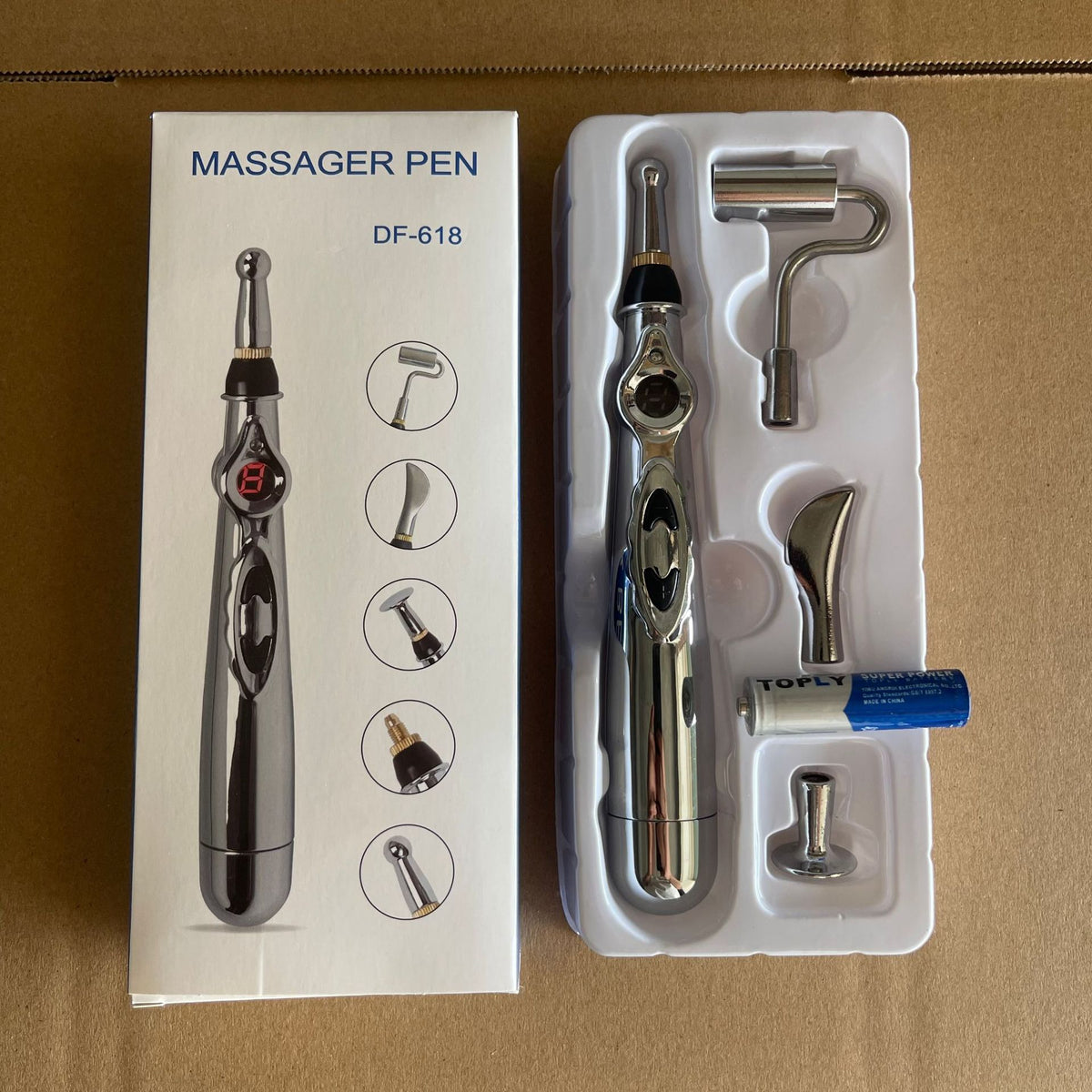 Image of Meridian Pen rechargeable acupoint massage tool in packaging with various heads and battery.